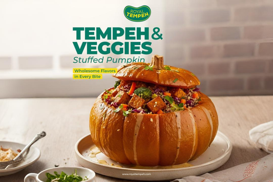 Royal Tempeh & Veggies stuffed pumpkin filled with colorful vegetables and tempeh cubes, drizzled with sauce for a wholesome plant-based dish.