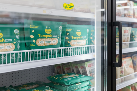 Royal Tempeh packs neatly displayed in a supermarket freezer, highlighting USDA-certified plant-based protein options.