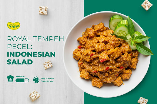 Royal Tempeh pecel Indonesian salad with tempeh in peanut sauce, served with cucumber and basil.