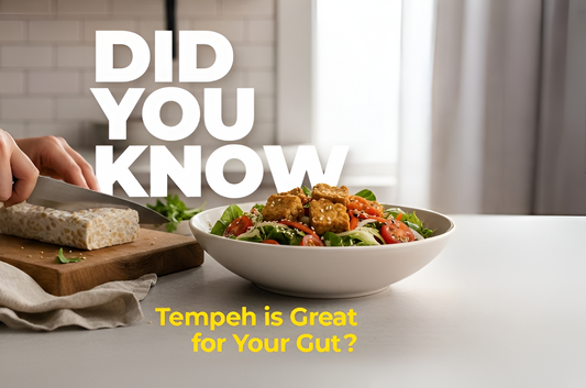 Person slicing a block of tempeh beside a bowl of fresh salad topped with tempeh cubes, with bold text reading 'Did You Know Tempeh is Great for Your Gut?