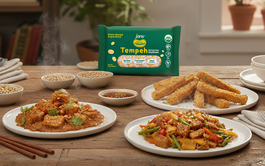 Royal Tempeh pack displayed with three plated dishes: tempeh curry, crispy tempeh fries, and stir-fried tempeh with vegetables, surrounded by soybeans and dipping sauce.