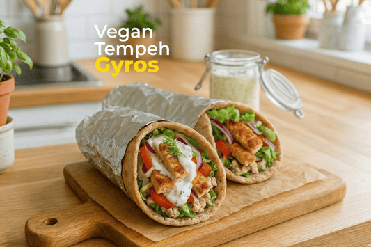 Vegan tempeh gyros wrapped in pita with fresh vegetables and creamy sauce.