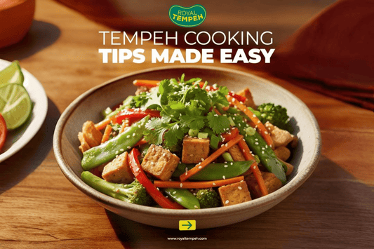Stir-fried tempeh with fresh vegetables, topped with sesame seeds and cilantro in a bowl.