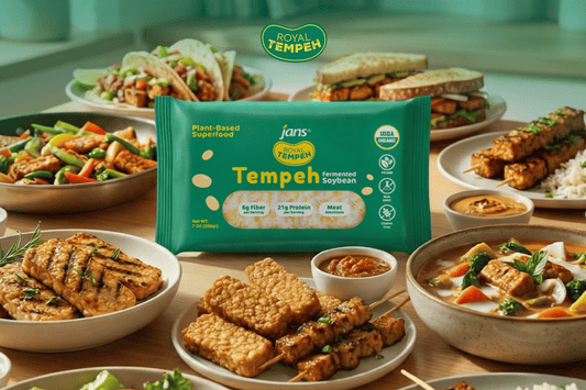 A green retail pack of Jans Royal Tempeh displayed in the center, surrounded by a variety of cooked tempeh dishes including skewers, bowls, stir-fries, and tacos.