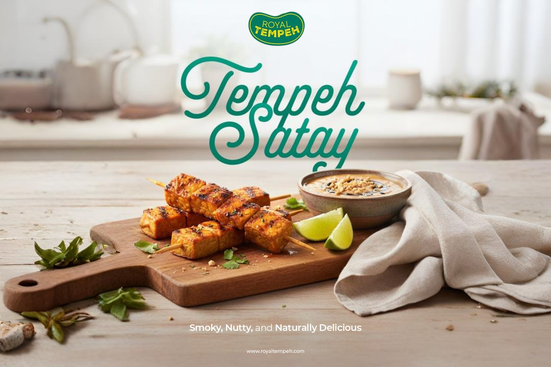 Royal Tempeh Satay skewers on a wooden board with peanut sauce and lime, tagline reads ‘Smoky, Nutty, and Naturally Delicious.