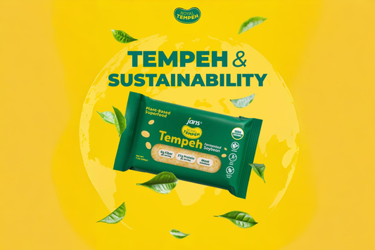 Royal Tempeh pack on a yellow background with floating green leaves promoting sustainability.