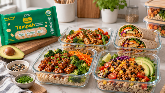 Glass containers filled with balanced vegan lunches and wraps featuring sliced and seasoned Royal Tempeh, alongside a green package of Royal Tempeh on a kitchen counter.